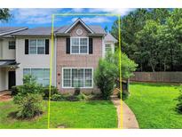 Charming townhome showcasing a well-manicured lawn and inviting facade with multi-pane windows allowing for natural light at 217 Odyssey Turn, Conyers, GA 30012