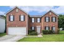 Charming two-story brick home with black shutters and a well-manicured front yard at 4438 Parmalee Path, Conley, GA 30288