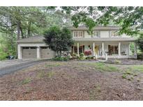 Traditional two-story home featuring painted brick, covered porch, and attached two-car garage at 2538 Anchors Way, Snellville, GA 30078