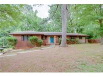 Charming brick ranch home with a bright blue front door and a well-maintained lawn at 3336 Forrest Hills Dr, Hapeville, GA 30354