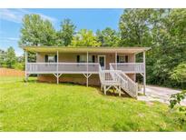 Charming single-Gathering home with a welcoming porch and well-maintained front lawn at 400 Rustin Dr, Dallas, GA 30157