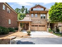 Charming two-story home with a brick and tan exterior and a two-car garage at 800 Old Plank Sq, Duluth, GA 30097