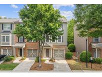 Charming townhome with a well-manicured lawn and an attached garage at 1464 Dolcetto Trce, Kennesaw, GA 30152