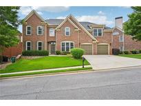 Beautiful brick two-story home with well-manicured lawn and a two-car attached garage at 5066 Healey Dr, Smyrna, GA 30082