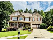 Charming two-story brick home with well-manicured lawn and inviting curb appeal at 1652 Park Hollow Ln, Lawrenceville, GA 30043