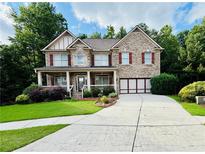 Charming two-story brick home with a manicured lawn and a spacious driveway at 1652 Park Hollow Ln, Lawrenceville, GA 30043