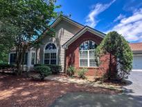 Charming home featuring brick and siding exterior, beautiful landscaping, and large windows, offering curb appeal at 3836 Vineyards Lake Nw Cir # U17, Kennesaw, GA 30144