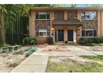 Charming townhouse featuring brick and stone accents, complemented by mature landscaping and a welcoming entrance at 100 Biscayne Nw Dr # C1, Atlanta, GA 30309
