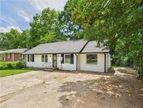 Charming single-story home with white painted brick, mature trees, and a private driveway at 2203 Second Ave, Decatur, GA 30032