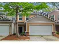 Charming townhome with a two-car garage and well-maintained landscaping at 3300 Suttles Sw Dr, Atlanta, GA 30331