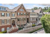 Charming townhome exteriors with brick and stone accents, featuring landscaped front yards and inviting entryways at 406 Mareeba Park # 61, Canton, GA 30114