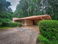 Charming single-story home featuring a covered carport and mature landscaping at 4714 Darlene Way, Tucker, GA 30084
