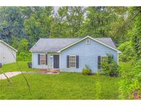 Charming single-story home featuring a well-maintained lawn and traditional architectural details at 7127 Greenway Sw Cv, Covington, GA 30014
