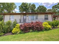Charming single-story home with a well-manicured lawn and colorful landscaping at 2646 Rockcliff Road Se, Atlanta, GA 30316