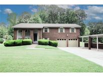 Charming two-story brick home featuring a two-car garage and covered parking area, beautifully landscaped front yard at 125 Pebble Beach Ct, Atlanta, GA 30349