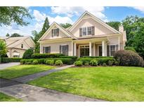 Charming home featuring a well-manicured lawn and lovely, trimmed greenery and sidewalk to the front door at 6186 Talmadge Nw Run, Acworth, GA 30101