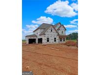 New two-story home construction featuring visible framing and Tyvek house wrap on a sunny day at 1500 Alcovy Station Rd, Covington, GA 30014