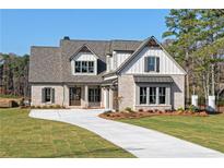 Charming two-story brick home with manicured lawn, inviting entry, and lovely architectural details at 1670 Knob Creek Nw Ct, Acworth, GA 30101