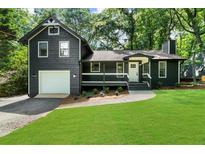 Charming home with a well-manicured lawn, attached garage and a cozy front porch at 1690 Eaglecreek Trl, Cumming, GA 30041