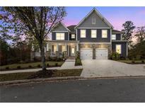 Beautiful two-story home with stone accents and a well-manicured front yard at twilight at 3198 Garden Hill Ln, Douglasville, GA 30135