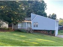 Charming two-story home with blue siding and a inviting front yard, perfect for outdoor enjoyment at 102 Bascomb Drive Dr, Woodstock, GA 30189