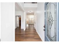 Inviting hallway features hardwood floors and a decorative glass front door at 264 Ascott Ln, Woodstock, GA 30189