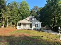 Charming one-story home with a well-manicured lawn and a long driveway at 4720 Fowler Cir, Acworth, GA 30101