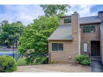 Charming townhouse featuring a cozy front entrance and well-maintained landscaping at 1301 Parkaire Xing, Marietta, GA 30068