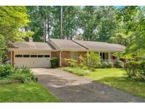 Charming brick ranch home with a two-car garage and lush landscaping at 1618 Mason Mill Ne Rd, Atlanta, GA 30329