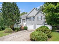 Charming two-story home with a manicured front yard and a two-car garage at 40 Browning Dr, Covington, GA 30016