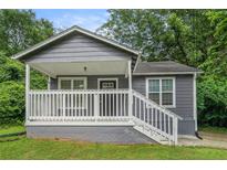 Charming home with a covered front porch and white railings, offering a welcoming curb appeal and outdoor space at 1328 Eason Nw St, Atlanta, GA 30314