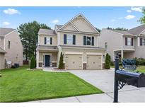 Charming two-story home with a well-manicured lawn and a two-car garage at 133 Worthing Ln, Fairburn, GA 30213