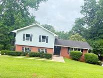 Charming two-story home with a brick-and-siding exterior and well-manicured landscaping at 3755 Greentree Dr, Decatur, GA 30032