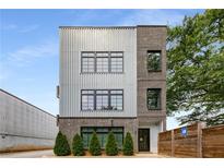 Modern exterior with brick and silver facade, complemented by well-placed windows and manicured greenery at 417 E College Ave # 302, Decatur, GA 30030