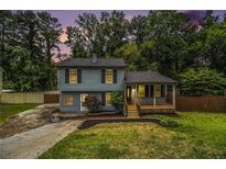 Charming two-story home with a welcoming front porch and nicely landscaped yard at 4835 Kellys Mill Nw Dr, Lilburn, GA 30047