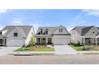 Charming single-Gathering home boasting a manicured lawn, stone accents, and a welcoming covered porch at 1649 Tielman Way, Snellville, GA 30078