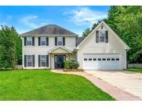 Inviting two-story home with a well-manicured lawn and attached two car garage at 3227 Ivy Lake Ct, Buford, GA 30519