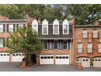 Charming brick townhome with manicured landscaping and multi-car garage in a desirable neighborhood at 433 The North Chace, Atlanta, GA 30328