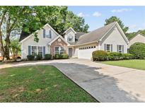 Charming traditional home with manicured lawn, stone accents, and attached two-car garage at 4042 Laurel Bend Ct, Snellville, GA 30039