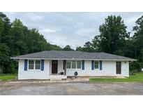 Charming single-story home featuring blue shutters and a well-manicured front yard at 410 S Gordon Sw Rd, Mableton, GA 30126