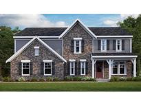 Charming two-story home showcasing a brick facade, gray siding, complemented by a well-manicured lawn and detailed trim at 250 Willow Bend Rd, Hiram, GA 30141