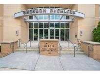 Emerson Overlook building entrance with brick signage, accessible ramp and metal and glass doors at 326 Roswell Se St # 406, Marietta, GA 30060