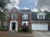 Charming two-story brick home with manicured landscaping and attached two car garage at 4189 Duncan Ives Dr, Buford, GA 30519