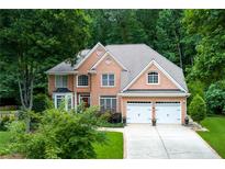 Stunning brick two-story home with a two-car garage and mature trees at 3245 Bywater Trl, Roswell, GA 30075