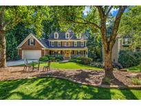 Charming two-story home with a landscaped front yard and a cozy seating area at 441 Belgrave Ln, Tucker, GA 30084