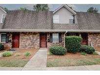 Charming brick townhome with well-maintained landscaping and a welcoming entrance at 3101 Reeves Se St, Smyrna, GA 30080