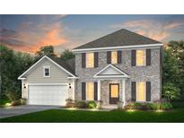 Charming two-story brick home with attached garage, manicured lawn, and well-lit walkway at 3176 Morris Hills Dr, Dacula, GA 30019
