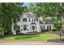 Charming two-story home with white exterior, black shutters, landscaped yard, and a welcoming front entrance at 1755 Noblin Summit Dr, Duluth, GA 30097