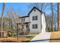 Attractive two-story home with white siding, black trim, gabled roof, and a concrete driveway at 2860 3Rd Sw Ave, Atlanta, GA 30315