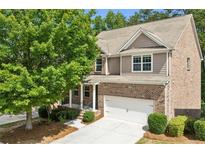 Charming two-story brick home with attached two-car garage and well-maintained landscaping at 1648 Danbury Parc Ne Pl, Brookhaven, GA 30319
